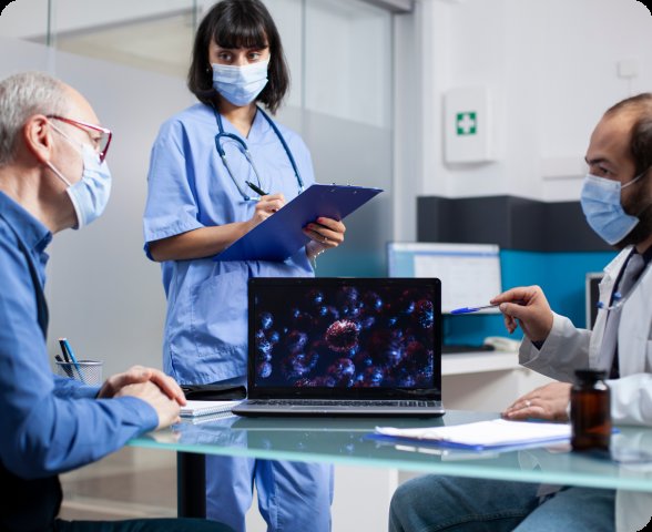 Healthcare team reviewing patient data on laptop — interoperability and data exchange