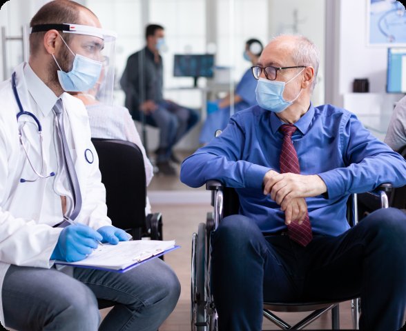 Doctor consulting with patient in wheelchair — patient engagement